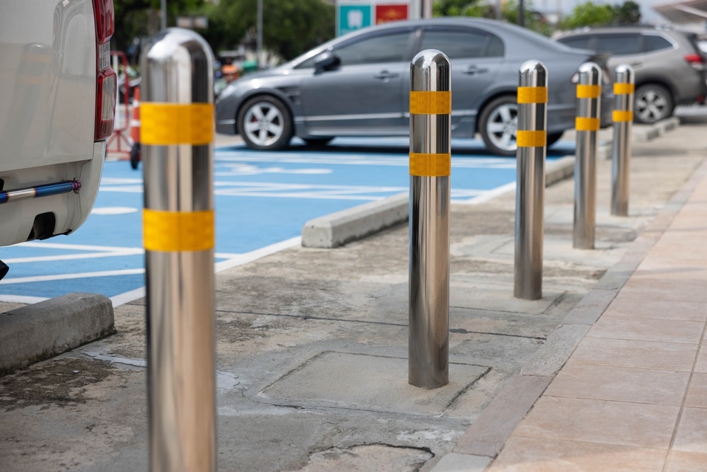 Stainless steel safety bollards beside accessible parking bays