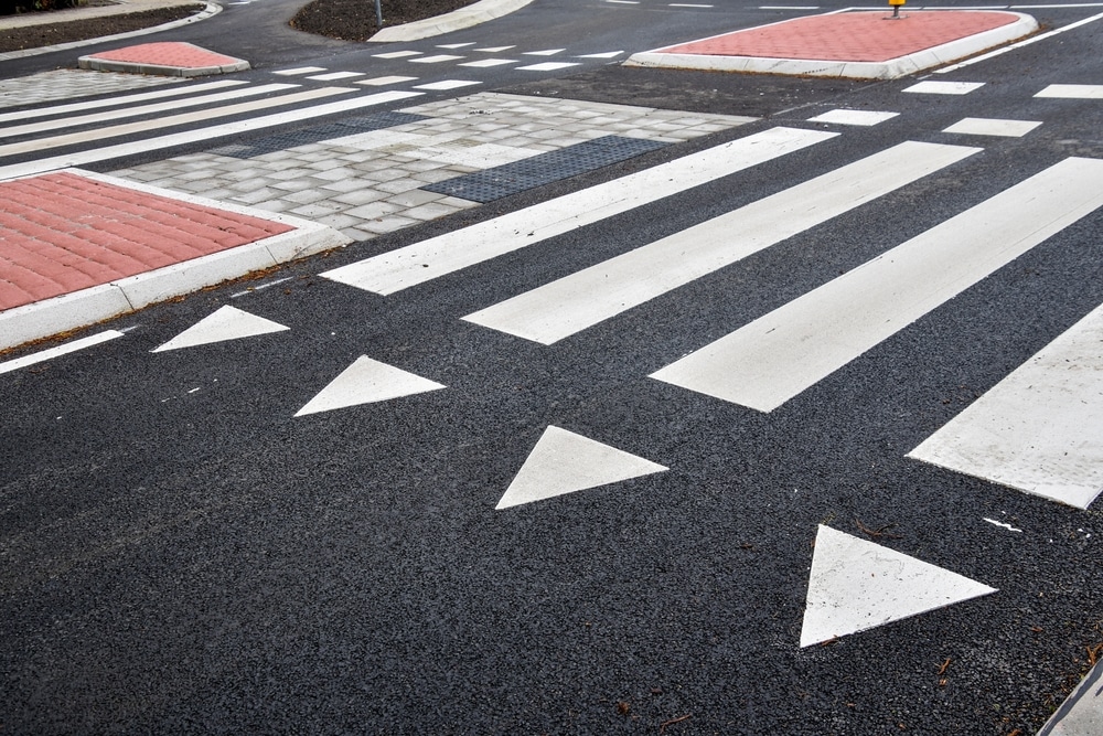Pedestrian crossings and directional markings at a road intersection
