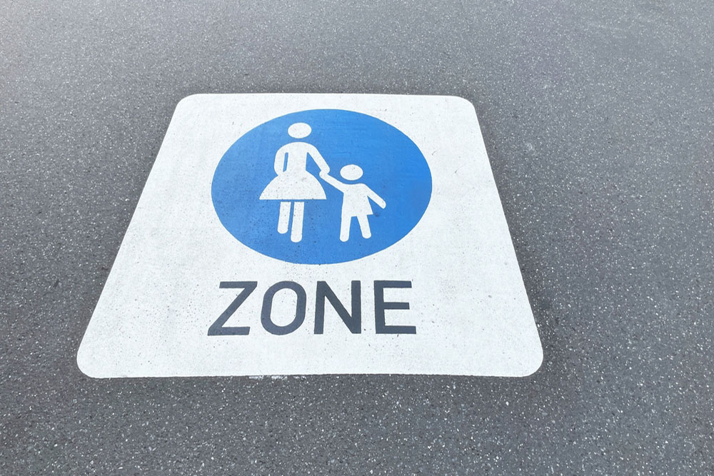 Parent and child zone pavement marking on asphalt