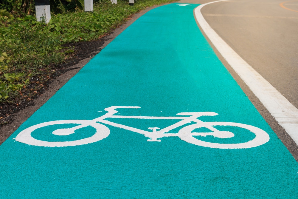 Green cycle lane with a white bicycle pavement symbol